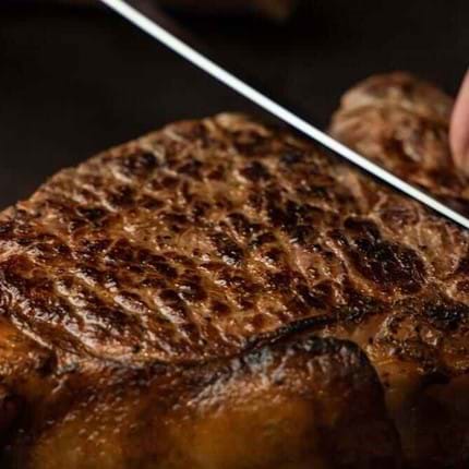 knife cutting through steak