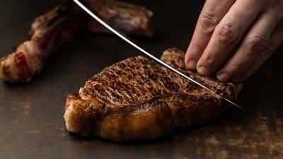 knife cutting through steak