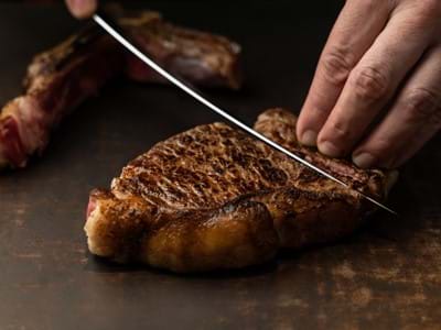 knife cutting through steak