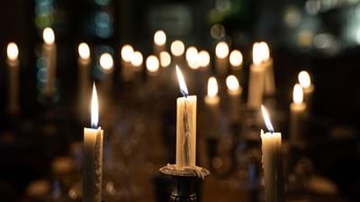 close up lit candles on table