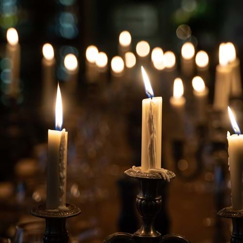 close up lit candles on table