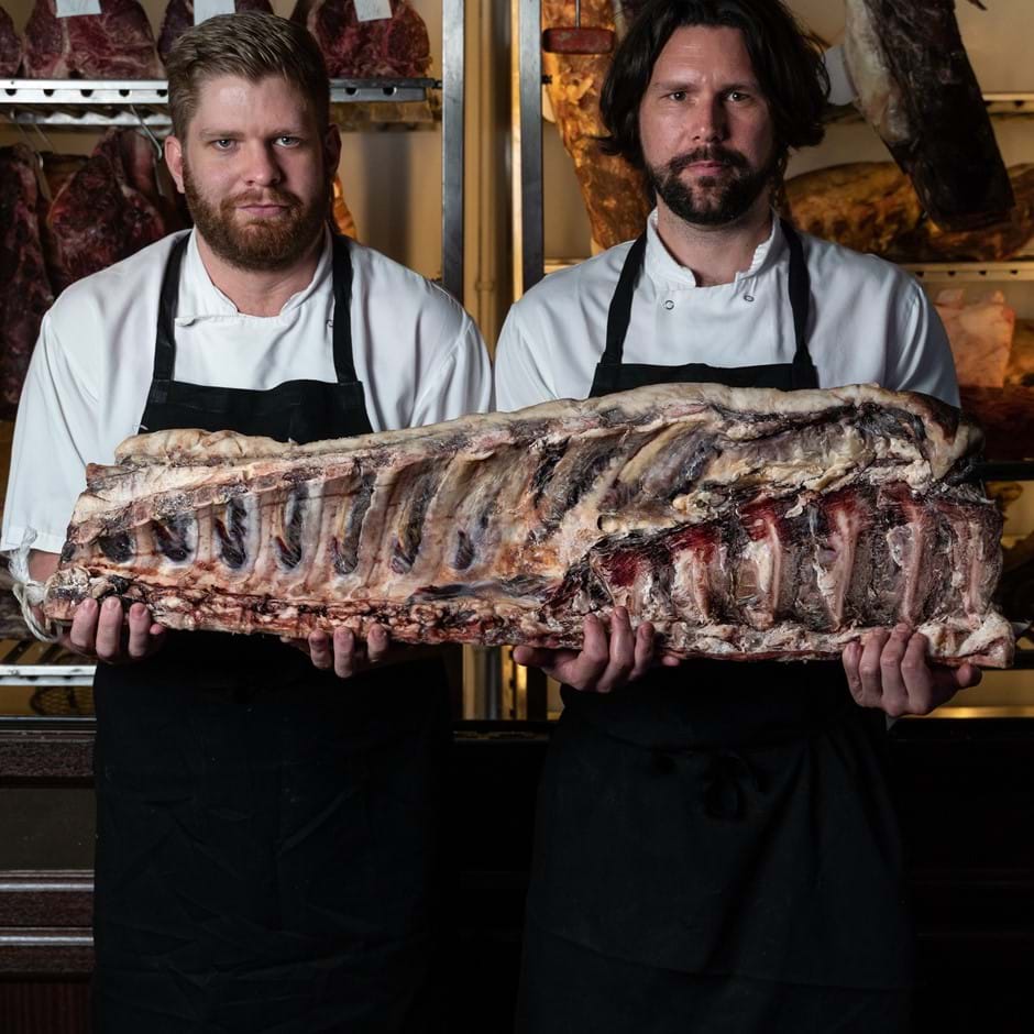 chefs holding meat