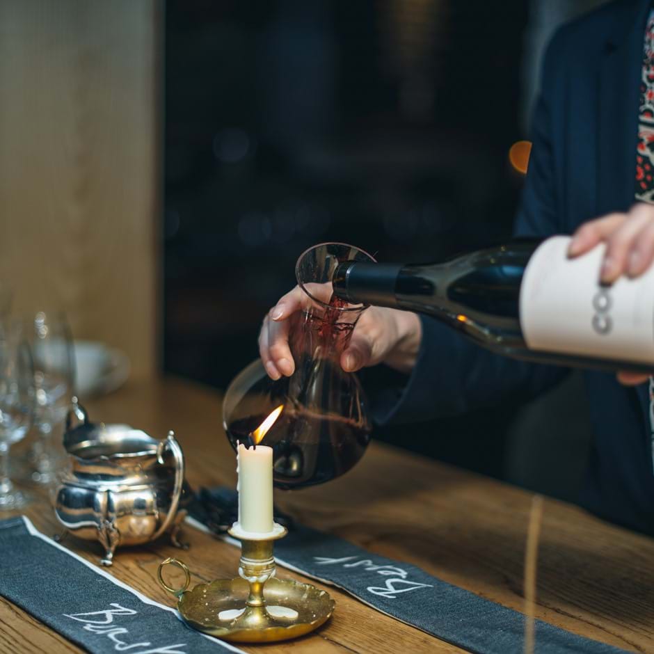 pouring red wine into glass