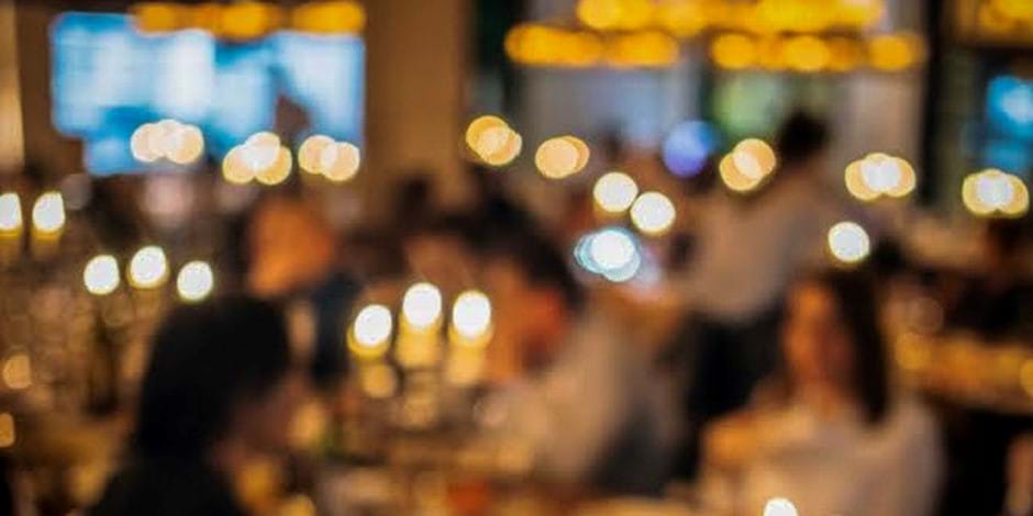 blurry image of people dining in restaurant