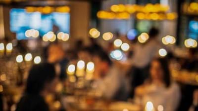 blurry image of people dining in restaurant