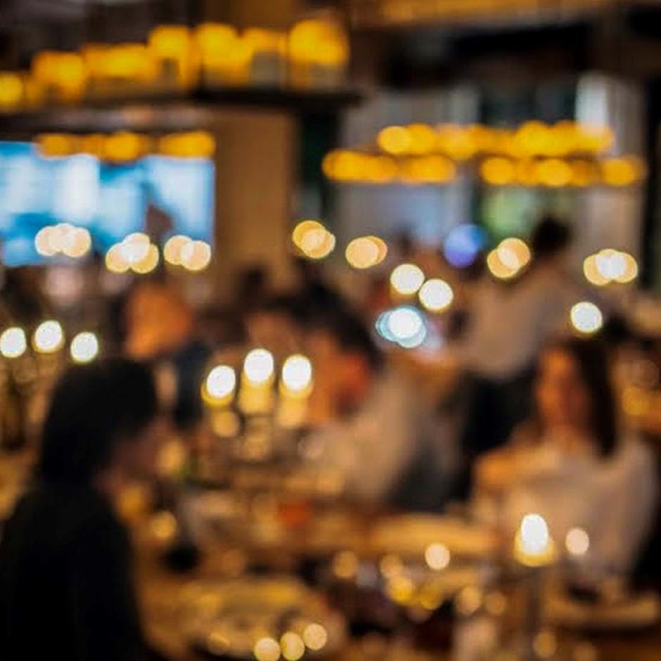 blurry image of people dining in restaurant